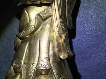 An inscribed Chinese gilt bronze figure of Buddha standing, Qianlong