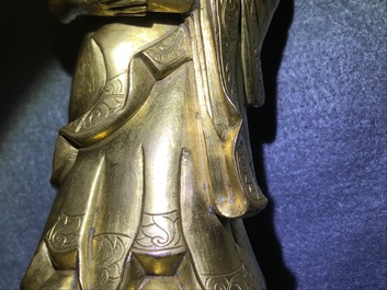 An inscribed Chinese gilt bronze figure of Buddha standing, Qianlong