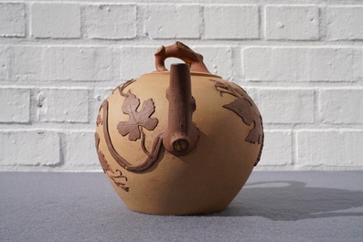 A large Chinese Yixing stoneware teapot with applied grape vines design, Kangxi