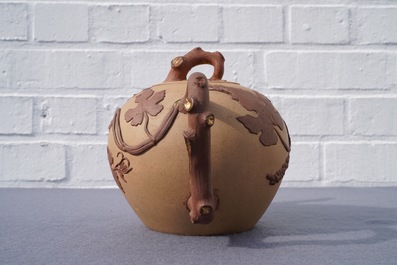 A large Chinese Yixing stoneware teapot with applied grape vines design, Kangxi