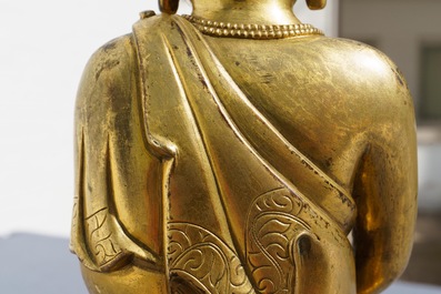 An inscribed Chinese gilt bronze figure of Buddha standing, Qianlong