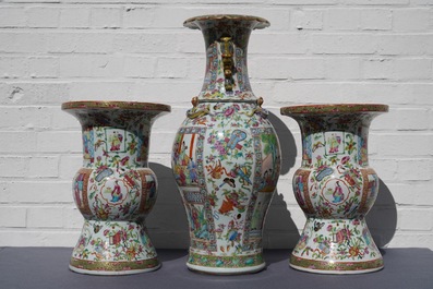 A pair of Chinese Canton famille rose spittoons and a vase, 19th C.