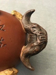 A Chinese Yixing stoneware relief-decorated teapot with nuts and fruits, Shao Er Quan mark, Daoguang