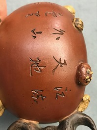 A Chinese Yixing stoneware relief-decorated teapot with nuts and fruits, Shao Er Quan mark, Daoguang