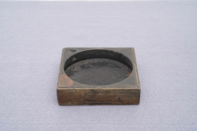 A square Chinese inscribed wood-encased duan inkstone, 19/20th C.