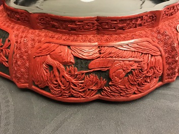 A Chinese cinnabar lacquer box and cover with figures in a landscape, 19th C.