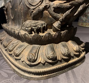 A large Chinese bronze group of Guanyin on a dragon, prob. Ming