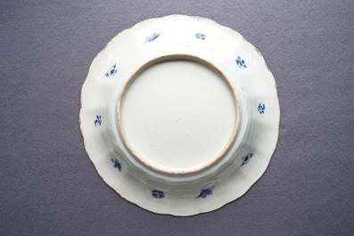 Two Chinese blue and white gadrooned 'crabs and carps' dishes and a pair of plates, Kangxi