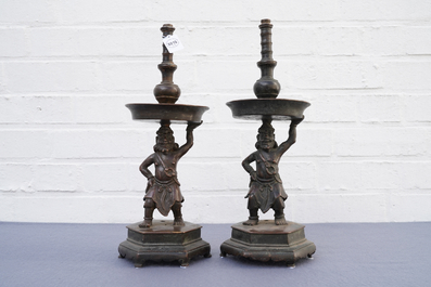 A pair of Chinese bronze candlesticks, Ming