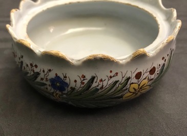 A pair of polychrome Dutch Delft butter tubs with ladies selling flowers and fruits, 18th C.