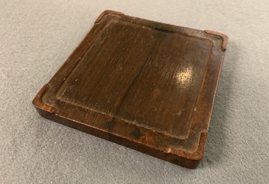 A square Chinese inscribed wood-encased duan inkstone, 19/20th C.