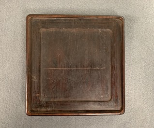 A square Chinese inscribed wood-encased duan inkstone, 19/20th C.