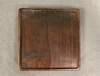 A square Chinese inscribed wood-encased duan inkstone, 19/20th C.