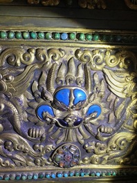 A turquoise-inlaid gilt bronze and copper repouss&eacute; 'tepchog' folding altar table, Tibet, 19th C.