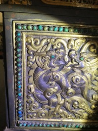 A turquoise-inlaid gilt bronze and copper repouss&eacute; 'tepchog' folding altar table, Tibet, 19th C.