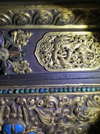 A turquoise-inlaid gilt bronze and copper repouss&eacute; 'tepchog' folding altar table, Tibet, 19th C.