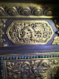 A turquoise-inlaid gilt bronze and copper repouss&eacute; 'tepchog' folding altar table, Tibet, 19th C.