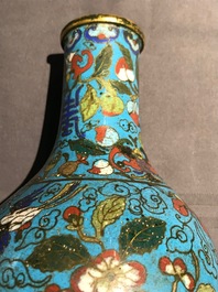 A Chinese cloisonn&eacute; bottle vase and a gilt bronze group, 18/19th C.