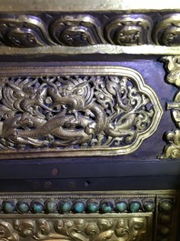 A turquoise-inlaid gilt bronze and copper repouss&eacute; 'tepchog' folding altar table, Tibet, 19th C.