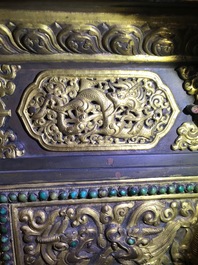 A turquoise-inlaid gilt bronze and copper repouss&eacute; 'tepchog' folding altar table, Tibet, 19th C.