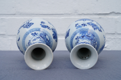 A pair of Chinese blue and white vases with antiquities and flowers, Kangxi