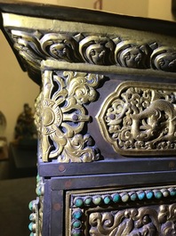 A turquoise-inlaid gilt bronze and copper repouss&eacute; 'tepchog' folding altar table, Tibet, 19th C.