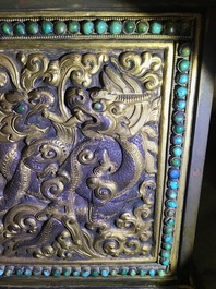 A turquoise-inlaid gilt bronze and copper repouss&eacute; 'tepchog' folding altar table, Tibet, 19th C.