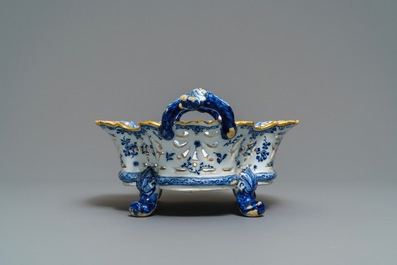 A reticulated Dutch Delft blue and white basket with a view on a wine cellar, 18th C.