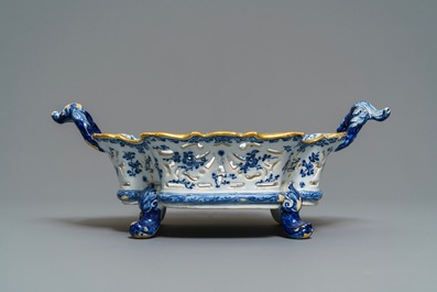 A reticulated Dutch Delft blue and white basket with a view on a wine cellar, 18th C.