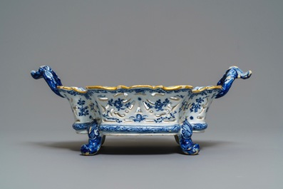 A reticulated Dutch Delft blue and white basket with a view on a wine cellar, 18th C.