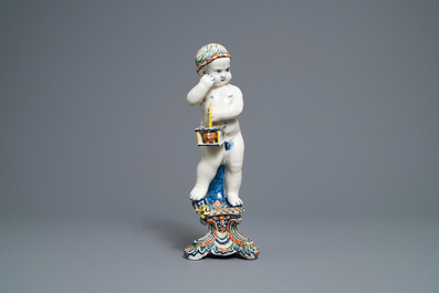 A polychrome Dutch Delft model of a boy, allegory of winter, 18th C.