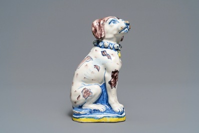 A polychrome Dutch Delft model of a dog, early 18th C.