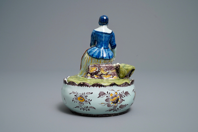 A polychrome Dutch Delft butter tub with a lady selling vegetables, 18th C.