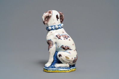 A polychrome Dutch Delft model of a dog, early 18th C.