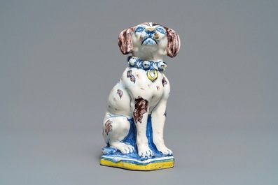 A polychrome Dutch Delft model of a dog, early 18th C.