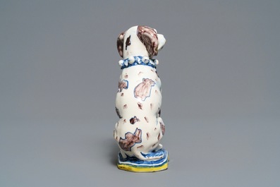 A polychrome Dutch Delft model of a dog, early 18th C.