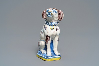A polychrome Dutch Delft model of a dog, early 18th C.