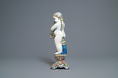 A polychrome Dutch Delft model of a boy, allegory of winter, 18th C.