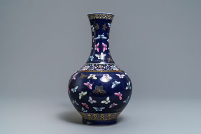 A Chinese blue-ground bottle vase with overglaze butterfly design, Guangxu mark, 19/20th C.