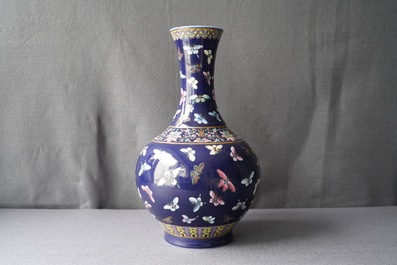 A Chinese blue-ground bottle vase with overglaze butterfly design, Guangxu mark, 19/20th C.