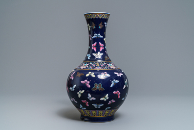 A Chinese blue-ground bottle vase with overglaze butterfly design, Guangxu mark, 19/20th C.