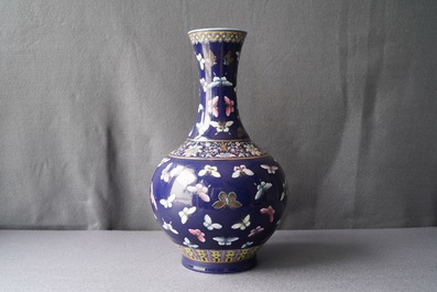 A Chinese blue-ground bottle vase with overglaze butterfly design, Guangxu mark, 19/20th C.