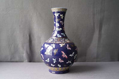 A Chinese blue-ground bottle vase with overglaze butterfly design, Guangxu mark, 19/20th C.