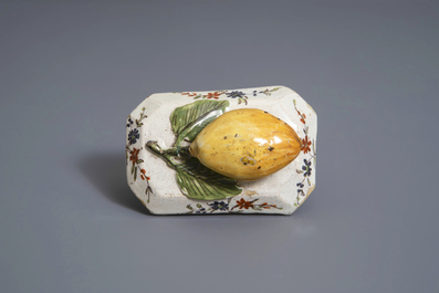 A polychrome Dutch Delft model of a lemon on a base, ca. 1800