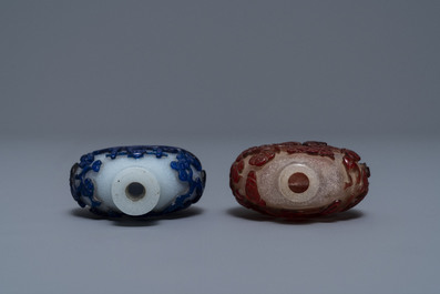 Two Chinese overlay red and blue snowflake glass snuff bottles, 19th C.