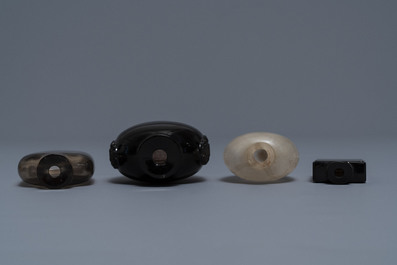 Four Chinese smoky quartz and simulating glass snuff bottles, 18/19th C.