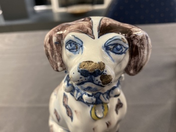 A polychrome Dutch Delft model of a dog, early 18th C.