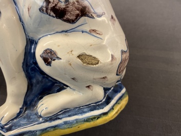 A polychrome Dutch Delft model of a dog, early 18th C.