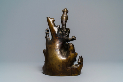 A large Chinese bronze group with Guanyin with child on a rock, Ming