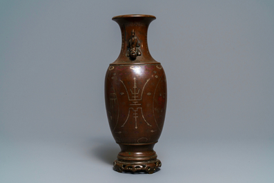 A Chinese or Vietnamese silver-inlaid and inscribed bronze vase, 19th C.